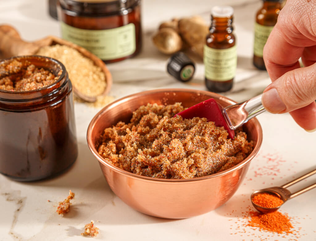 Hand mixing Gardener's Foaming Hand Scrub in a copper bowl